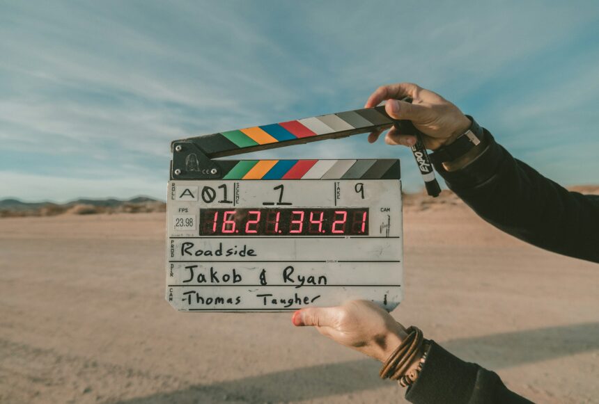 someone clapperboard a slate in front of the camera